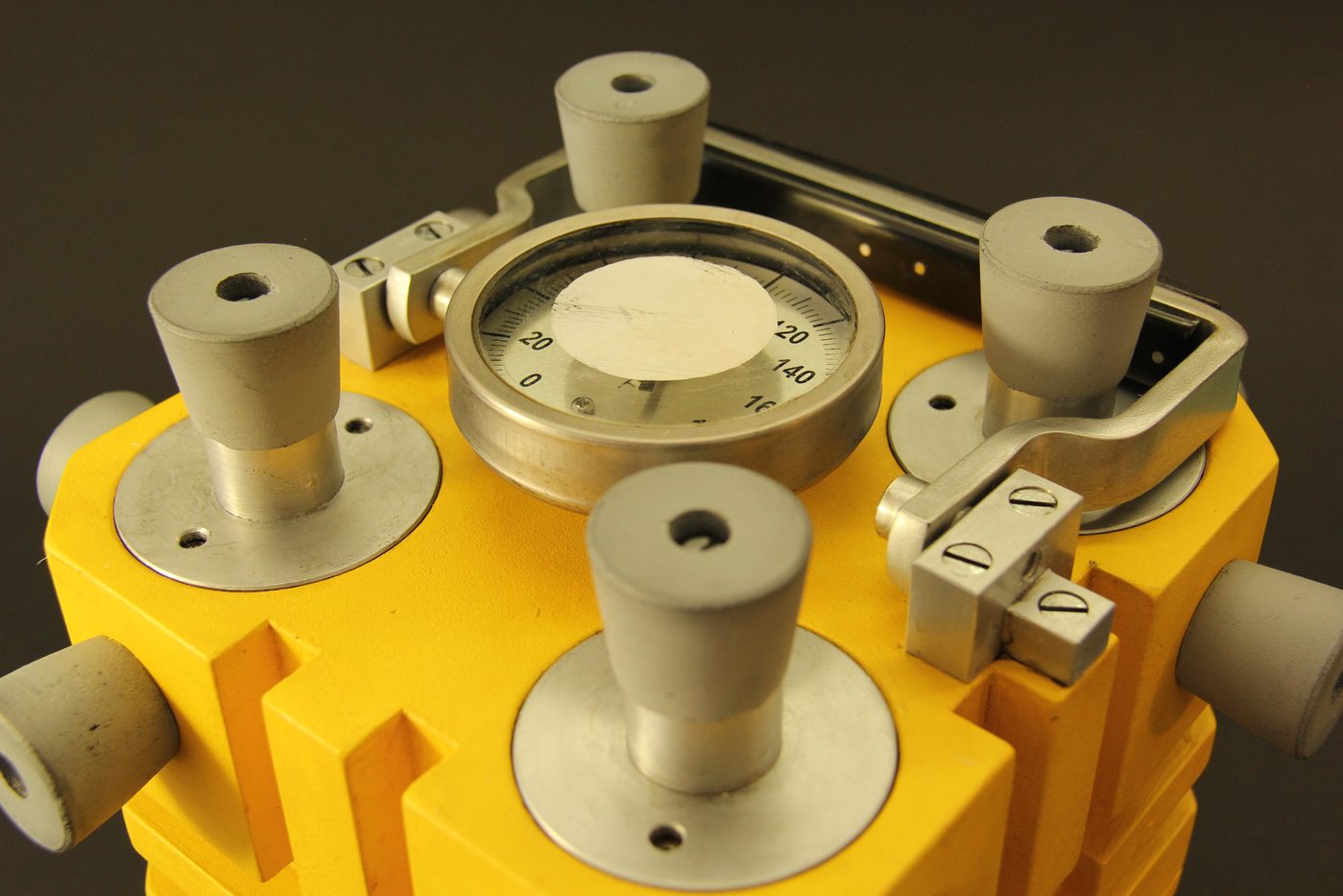 Figure 15 — Close-up of the top surface hardware on Ross Sackett's 2017 yellow-finish replica, showing the four urchin port plugs (knurled aluminum caps with spanner-wrench holes), the central process thermome…