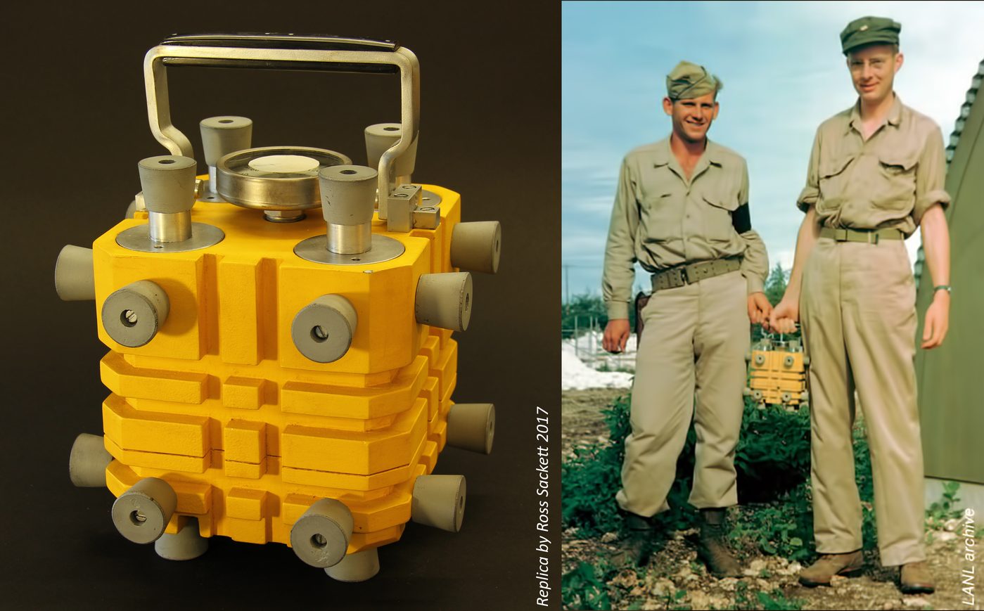 Figure 20 — Ross Sackett's 2017 yellow-finish replica (left) compared to the LANL archive photograph of the Fat Man box being carried on Tinian (right). The visual continuity between hobbyist replica and histo…